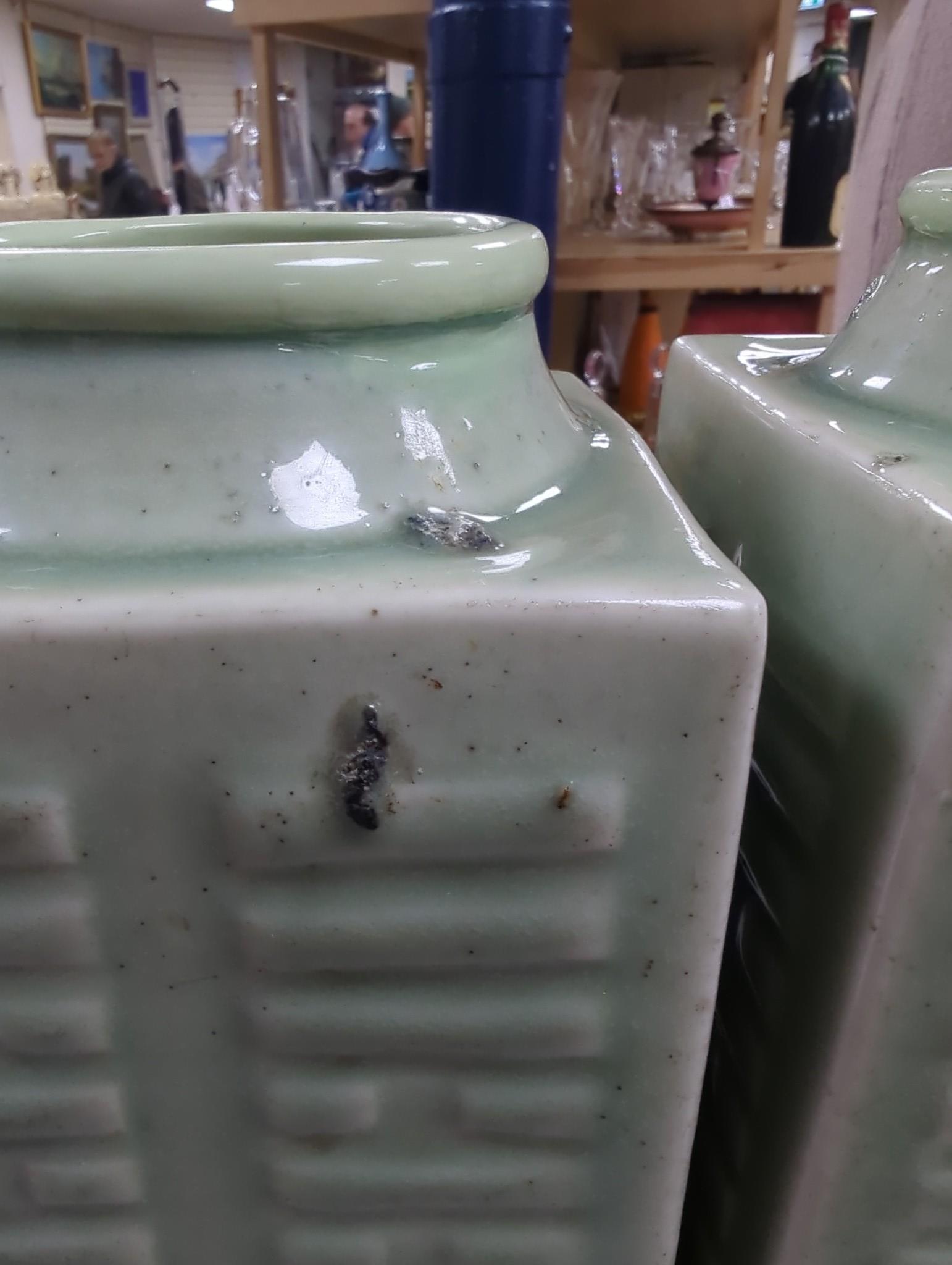A pair of early 20th century Chinese celadon glazed eight trigrams cong vases, 25cm